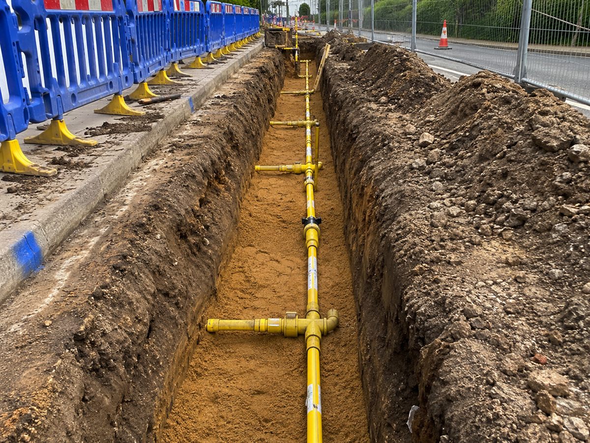 Commercial gas engineers in Glasgow Yellow underground gas main in a trench during pipework installation in Glasgow